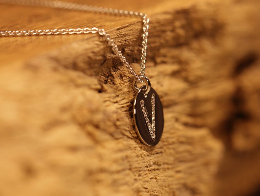 Anhänger in 585er Graugold mit einem V in Brillanten