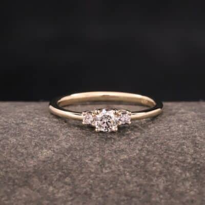 ring aus gelb gold mit drei steinen in krappenfassungen